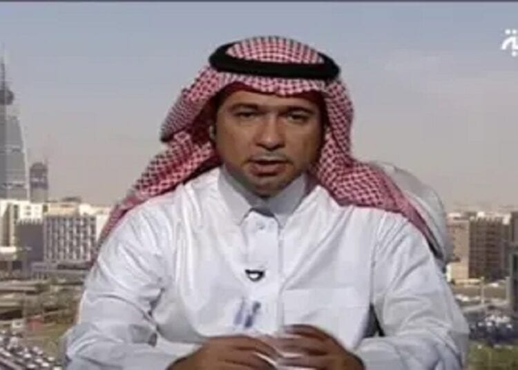 A man wearing a white thobe and red-and-white checkered ghutra sits in front of a cityscape with modern buildings. The logo of Al Arabiya is visible in the top right corner.